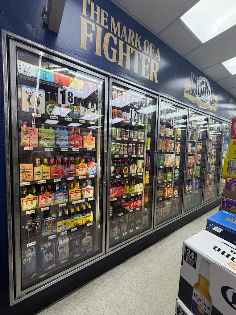 The walk-in cooler wall with Smirnoff Ice, Twisted Tea, Angry Orchard, and craft beer