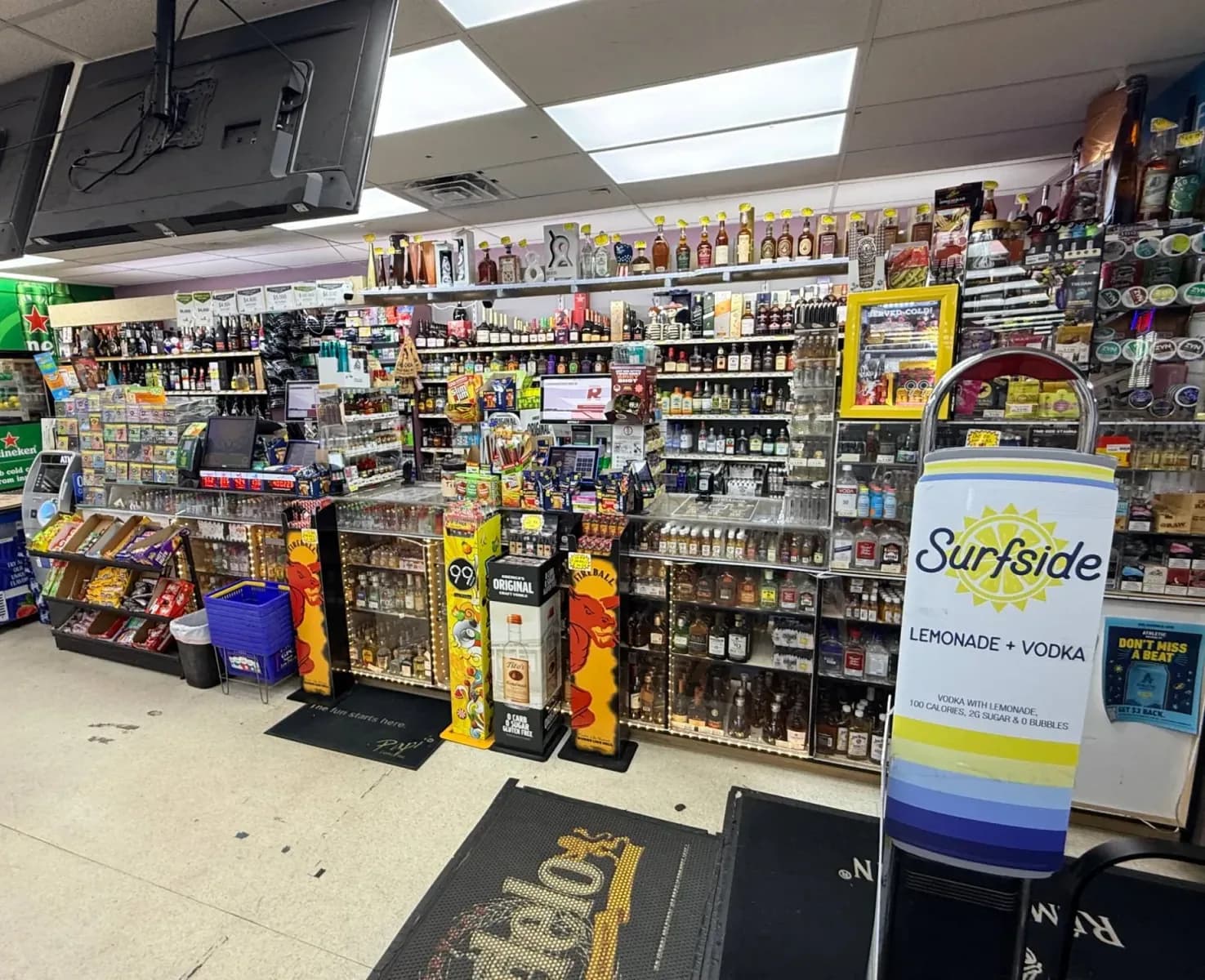 The front counter at HM Liquors, with spirits shelved behind the register