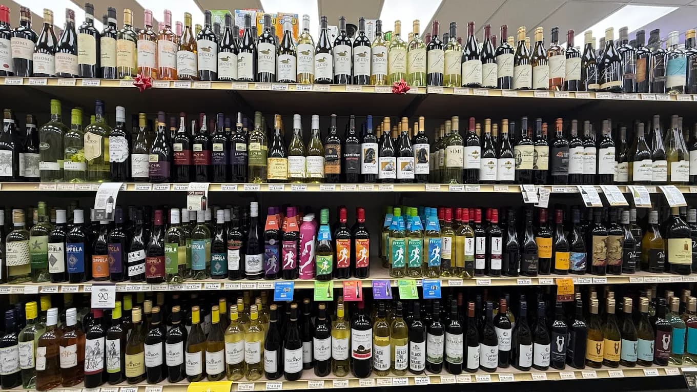 Shelves of wine including Decoy, Josh, Coppola, and FitVine